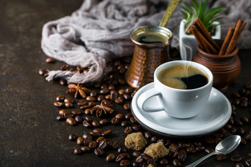 Black coffee in a cup on old background
