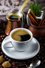 Black coffee in a cup on old background