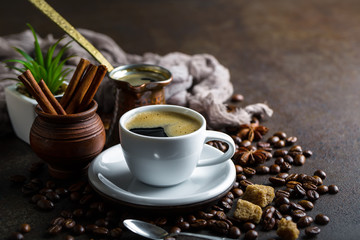 Black coffee in a cup on old background