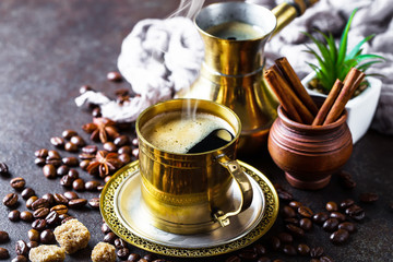 Black coffee in a cup on old background