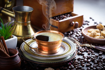 Black coffee in a cup on old background