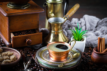 Black coffee in a cup on old background