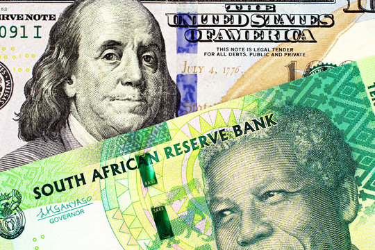 A Close Up Image Of A Blue American One Hundred Dollar Bill With A Ten South African Rand Bank Note