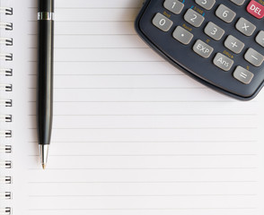 Close up of Pen with calculator and Notebook