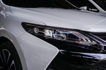 Fototapeta na wymiar car headlight on a white car