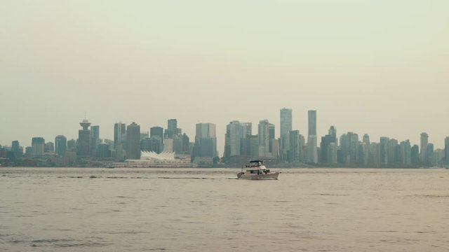 Sailing Yacht on cloudy day with Vancouver skyline in background