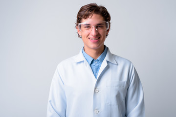 Young handsome man doctor wearing protective glasses