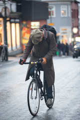 Man struggling on bicycle head bowed