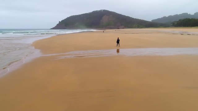 Man. Walking. Rodiles. Spain. Ocean. Beach. Water. Nature. Aerials. 4k. Drone