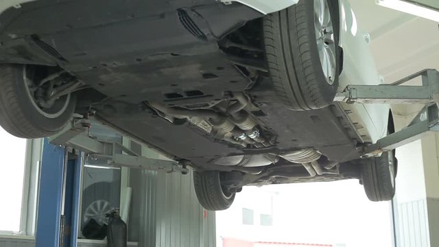The car is lifted on the lift for diagnosis.