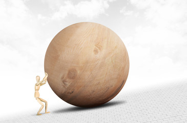 Man pushes a huge wooden ball upwards along the slope. Abstract image with a wooden puppet