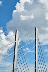 Detail of a bridge support structure with some clouds in the sky as background
