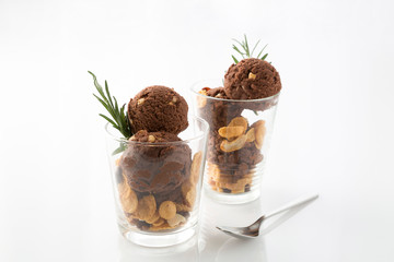 Chocolate ice cream in glasses on white table background