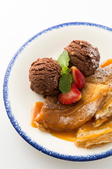 Chocolate ice-cream with crepes and strawberry