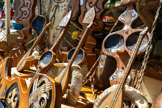 Kazakh national musical instruments handmade with horsehair strings for sale on a sunny day