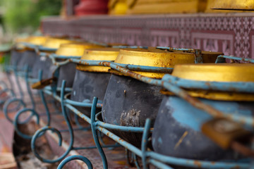 selected focus a row on buddhist monk's alms bowl , monk's alms bowl and Thai coin donation