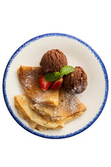 Chocolate ice-cream with crepes and strawberry isolated on background