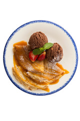 Chocolate ice-cream with crepes and strawberry isolated on background