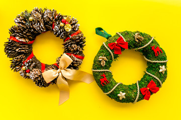 Set of different festive christmas wreath on yellow background top view