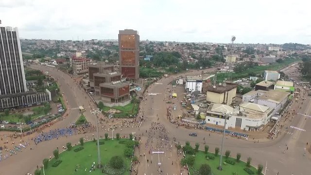 Rising shot of the main parade in Yaounde as the city center is in full view as the shot rises to fly out of the city.