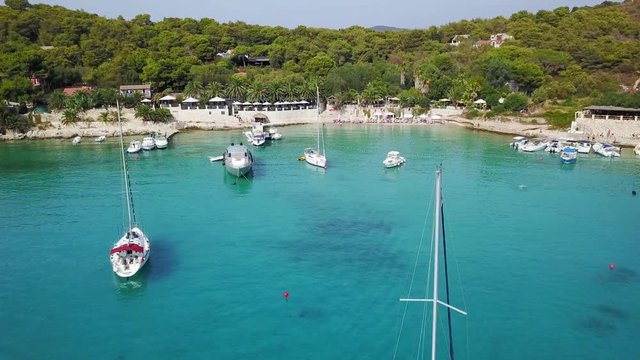 Sailing boat at anchor in bay on island Palmizana in Croatia. Aerial footage of Adriatic sea.
