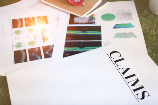 The blurry light design background of the Lasic X-Ray  result put beside claims paper sheet,