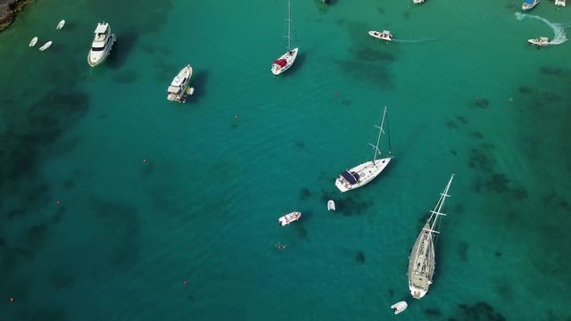Sailing and motor boats at anchor in bay on Palmizana island in Croatia.