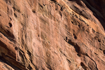Red rock wind worn texture at sunrise