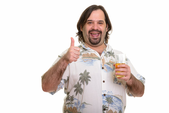 Happy fat Caucasian man smiling while giving thumb up and holdin