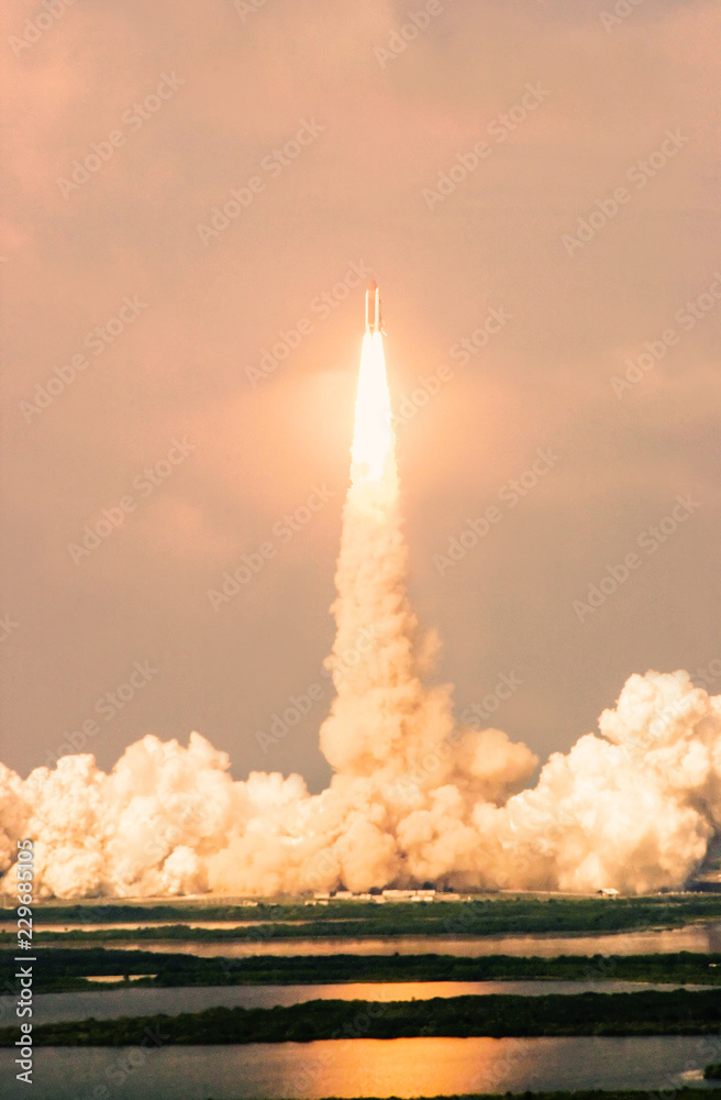 Wall mural launch of the spaceship from the spaceport in the morning flight of space shuttle in clouds of smoke