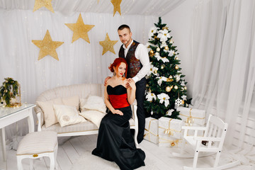 A man holds his wife's shoulders in white room