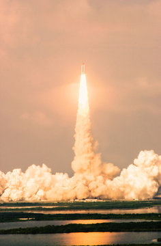 Launch of the spaceship from the spaceport in the morning Flight of space shuttle in clouds of smoke. Some elements of this image are furnished by NASA