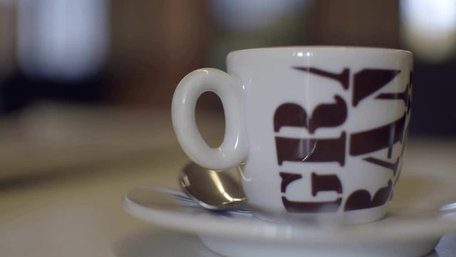 Cup of Italian espresso macchiato coffee lateral view.
Tazzina di caff&radic;&reg; macchiato con zucchero di canna a pioggia