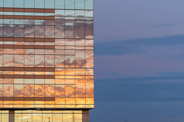 Business office building with colorful skies, reflecting the sunset colors of the glass windows