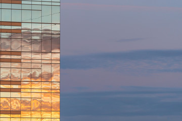 Business office building with colorful skies, reflecting the sunset colors of the glass windows