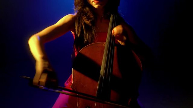 The cellist performs on stage.