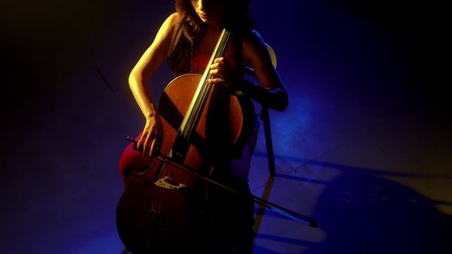 The cellist performs on stage.