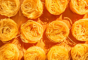 Dried pasta on a wooden board