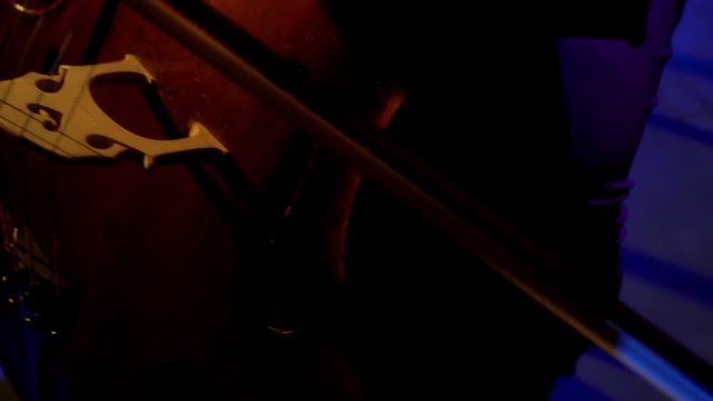 The cellist performs on stage.