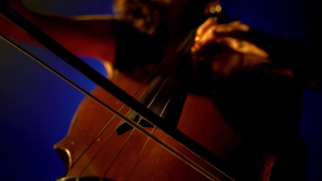 The cellist performs on stage.