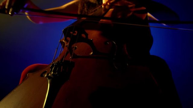 The cellist performs on stage.