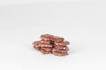 pieces of dark chocolate with nuts isolated on white.photo with 