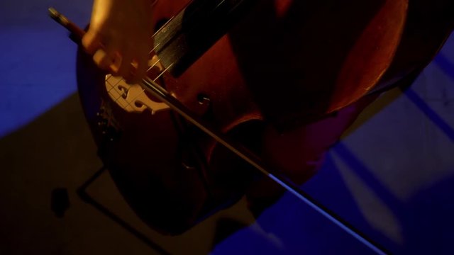 The cellist performs on stage.