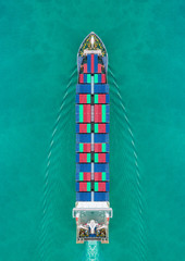 Aerial view container ship driving on the sea for delivery containers shipment. Suitable use for transport or import export to global logistics concept.