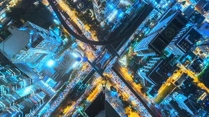 Poster Aerial view traffic road at night in downtown for transportation or traffic background. © Pawinee