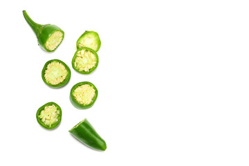 sliced green hot chili peppers isolated on white background top view