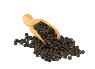 Black pepper on wooden scoop isolated on white background