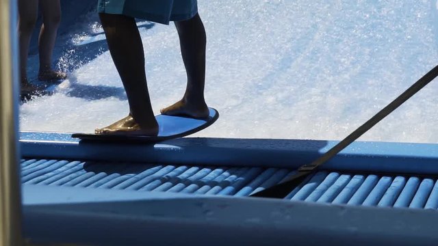 Skilled rider drops into wave machine and surfs slow motion