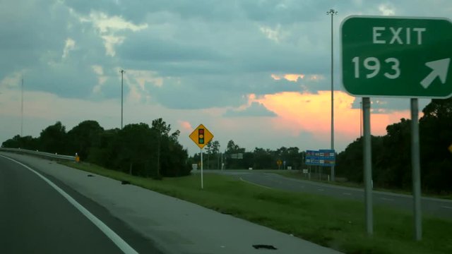 Doing down the highway, exit sign.