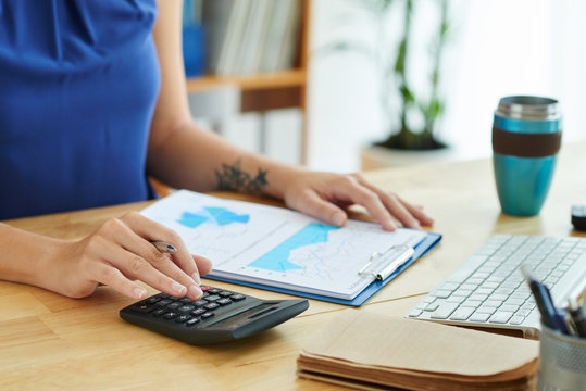 Professional accountant counting sum of income for annual report